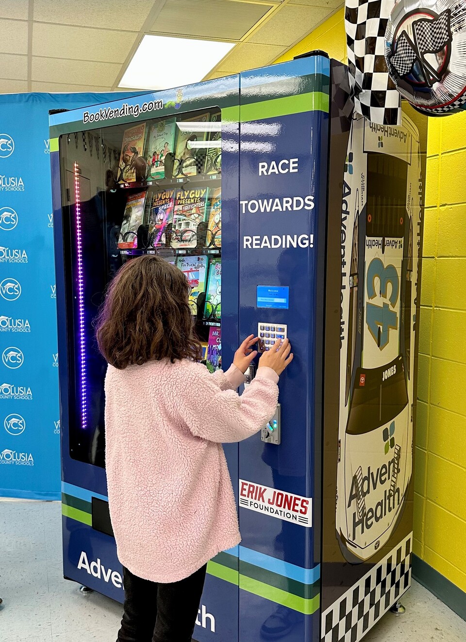 NASCAR Driver Reads to Children and Delivers a "Bookworm" Vending Machine to Volusia Elementary School