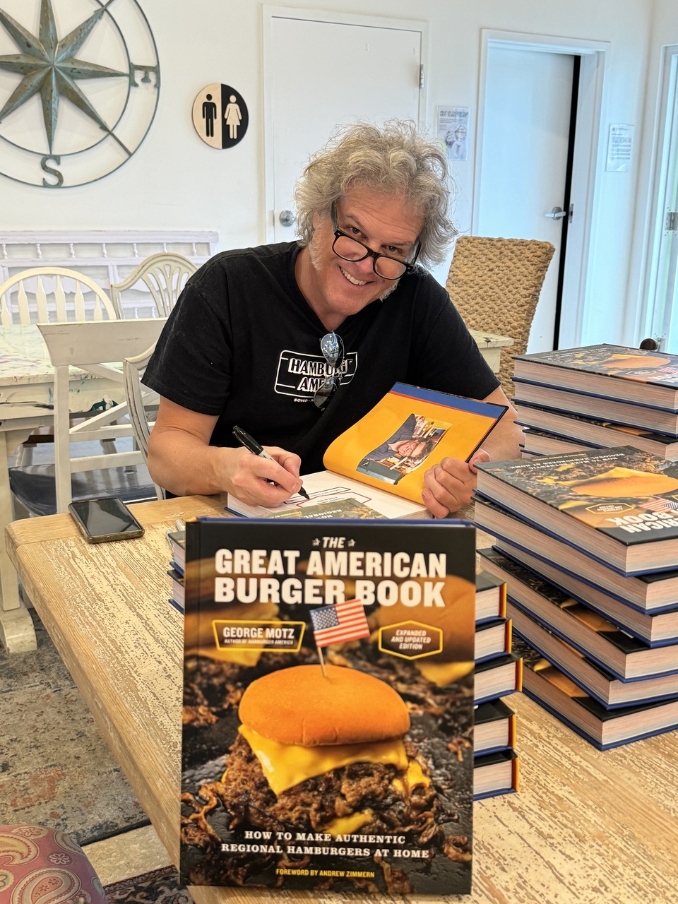 George Motz signing his book, "The Great American Burger Book" available wherever books are sold.