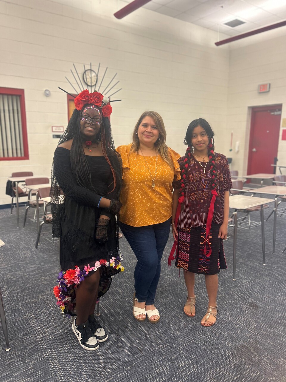 A Campbell Middle School student was awarded Best of Show for Traditional Dress. She is La Catrina on the left, Ja'Nyla Henry. Yalili Diaz-Sales was awarded 2nd place for her presentation on her Guatemalan Traditional Dress. Ms. Karelys Nunuz is their teacher, center.